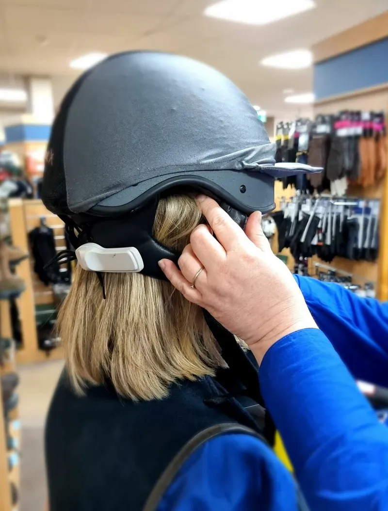trying on a riding hat